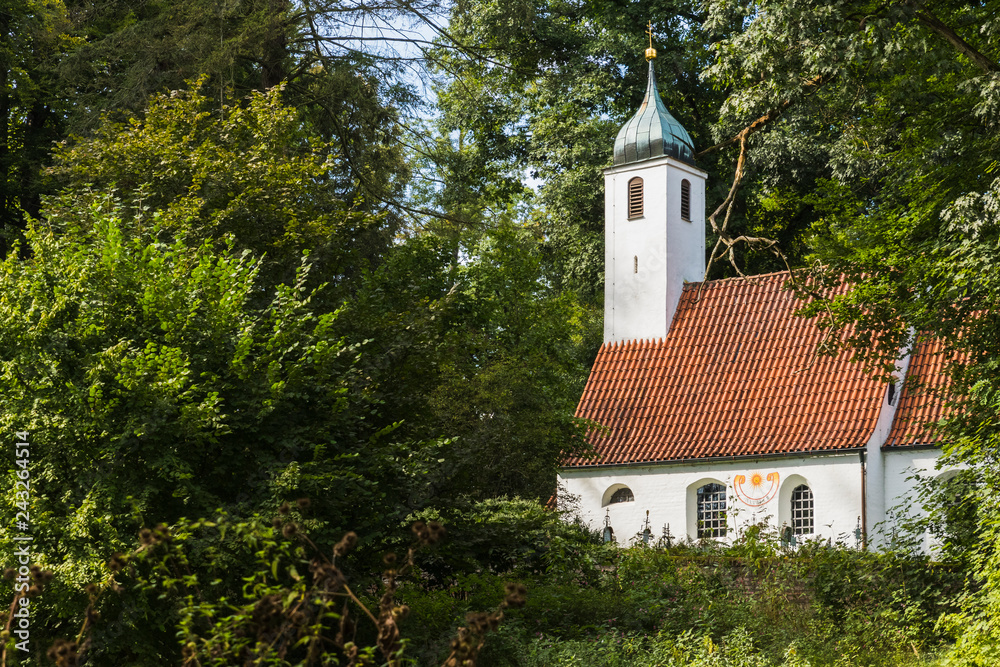 church hidden among the trees of a forest church hidden among the trees of a forest