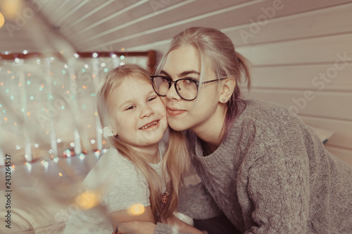 cozy photo session of two beautiful happy sisters in wooden house photo