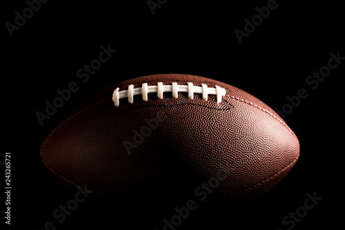 American football ball on dark background