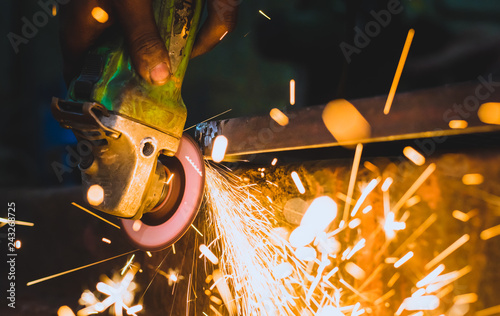 Man processes metal with an angle grinder