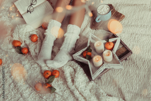 Women's legs in white knitted socks. photo in Hyugge style, photo