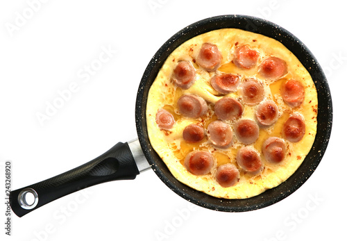 pan with scrambled eggs and sausages on a white background