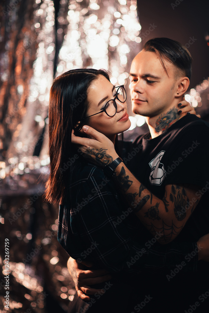 Couple in fashionable clothes on a shiny background Couple in fashionable clothes on a shiny background