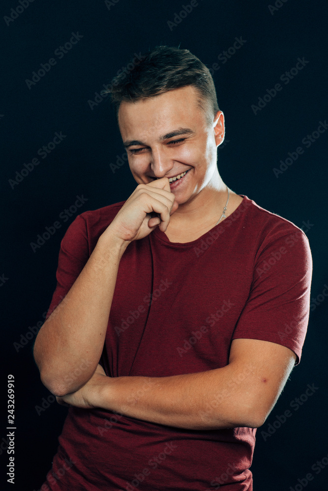 portrait of a young man on a dark background portrait of a young man on a dark background