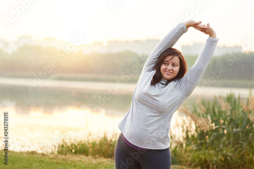 Smiling woman stretching her arms.