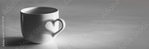Heart shaped shadow on a coffee cup, black and white