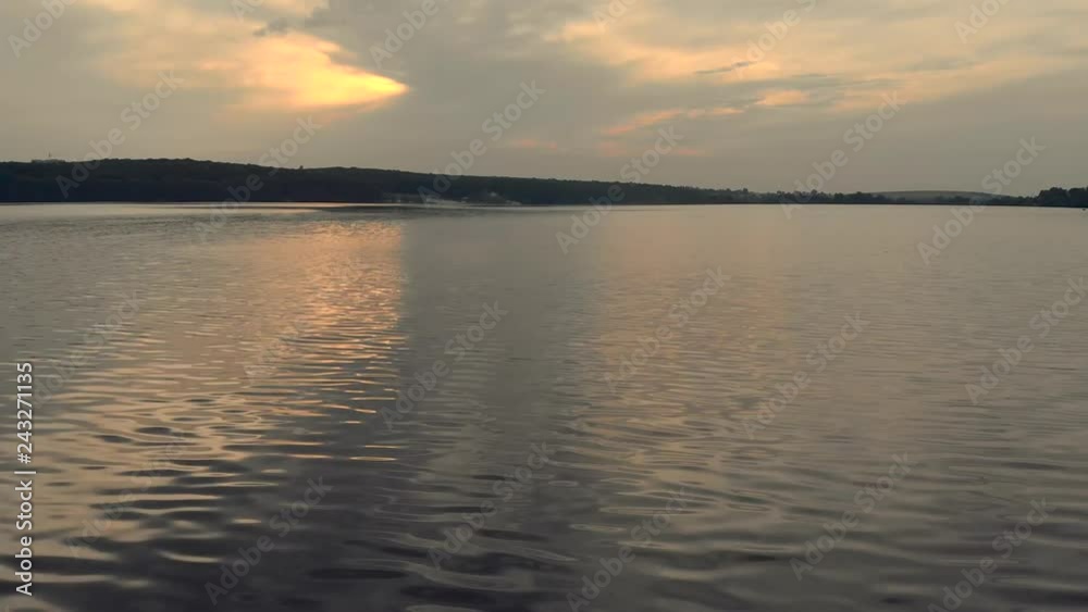 aerial drone slow flying over the water at sunset on summer aerial drone slow flying over the water at sunset on summer