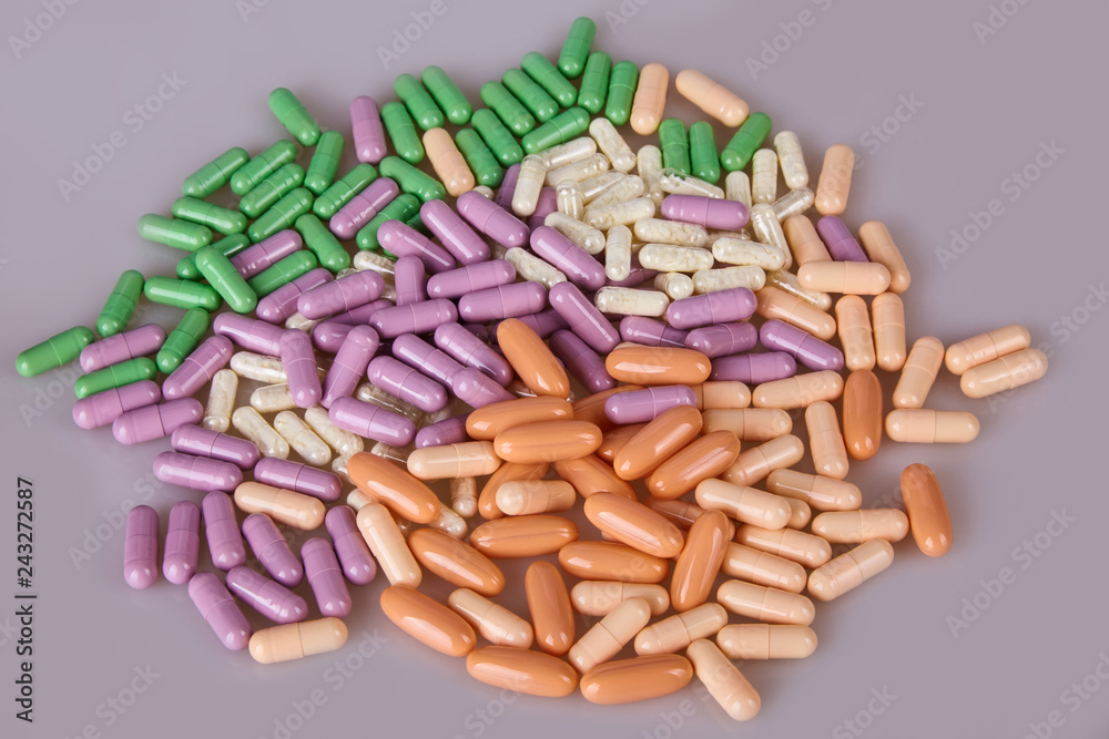 Spilled different capsules on the white background. Vitamin supplements tablets Spilled different capsules on the white background. Vitamin supplements tablets