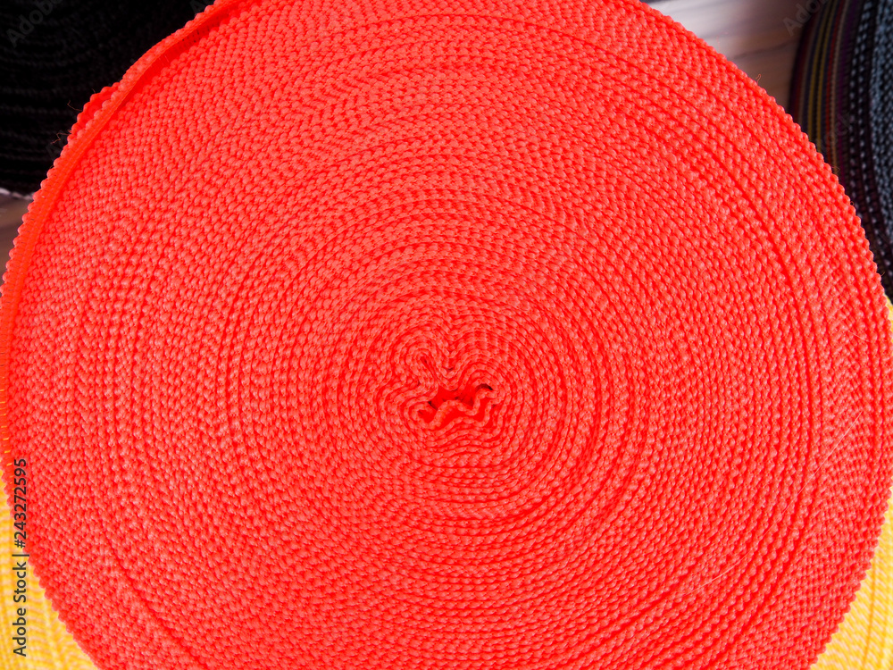 Ribbon of different colors in coils, many multi-colored coils for textile industry, clothing manufacturing Ribbon of different colors in coils, many multi-colored coils for textile industry, clothing manufacturing