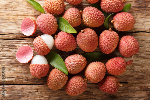 litchi, lichee, lychee, or lichi, Litchi chinensis on old rustic wood background. Horizontal top view
