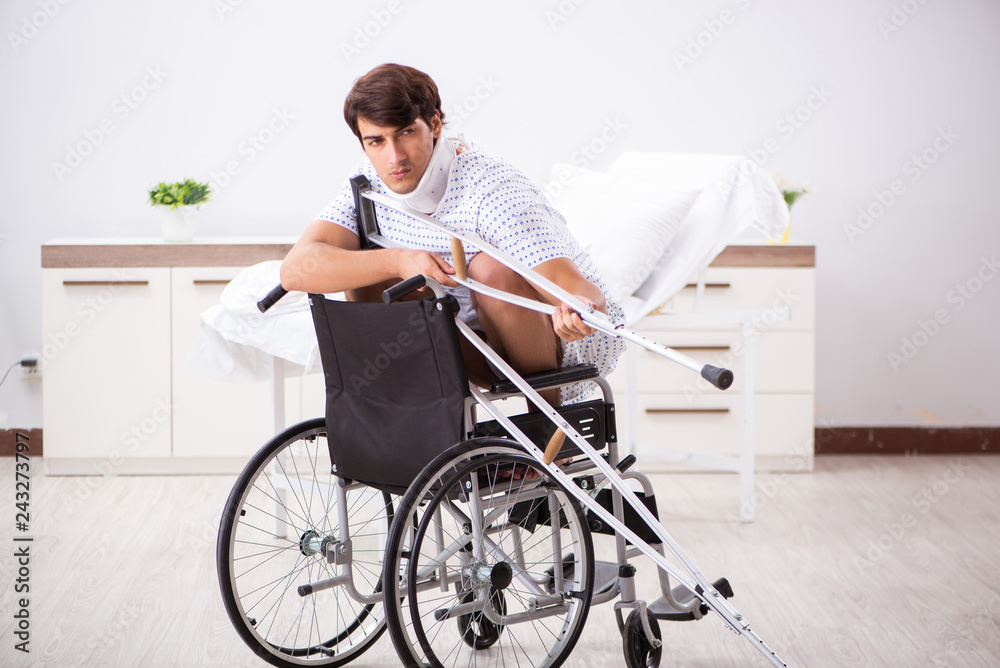 Young handsome man in wheelchair at the hospital Young handsome man in wheelchair at the hospital