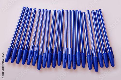 Blue plastic pens isolated on white photo