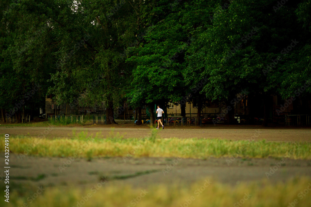 Athletic young man running in nature. Healthy lifestyle Athletic young man running in nature. Healthy lifestyle