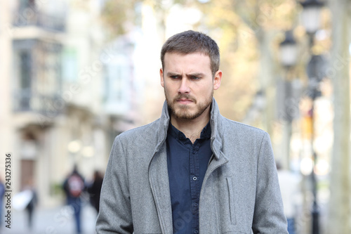 Angry man walking in the street