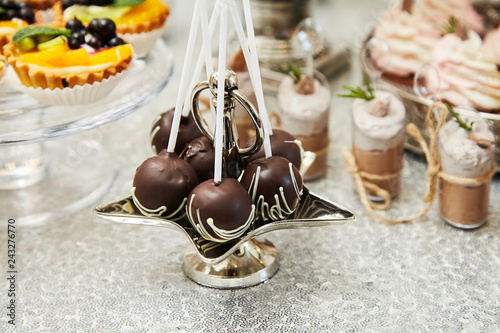Candy bar. Festive table with deserts,  tartlets, cookies and cakepops.