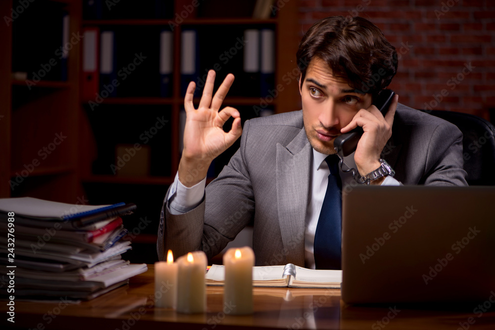 Businessman working late in office with candle light Businessman working late in office with candle light