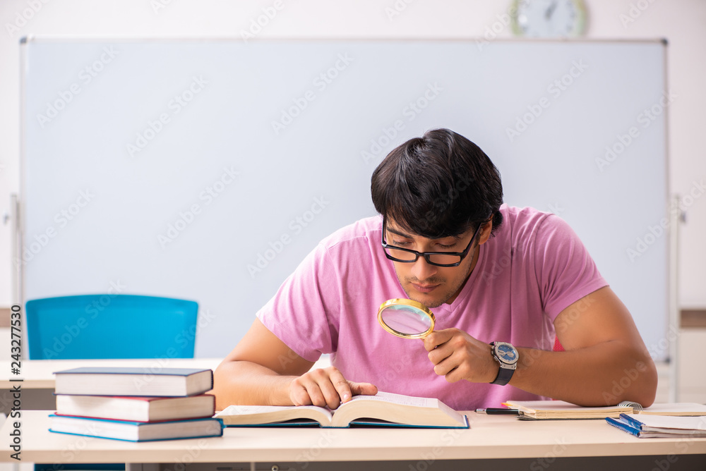 Young male student sitting in the class Young male student sitting in the class