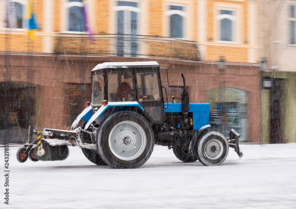 Snow removal machine cleaning the street from snow Snow removal machine cleaning the street from snow