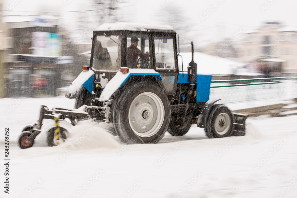Snow removal machine cleaning the street from snow Snow removal machine cleaning the street from snow