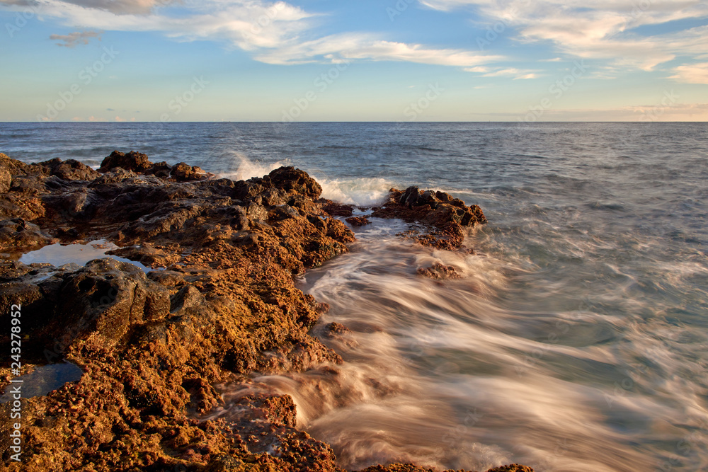 Waves break into shore.