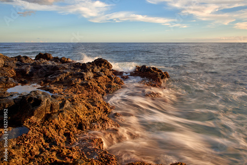 Waves break into shore.