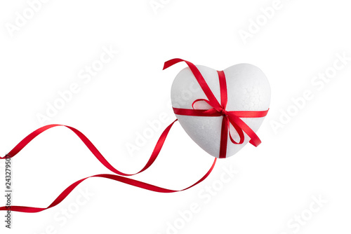 White foam heart tied with a red satin ribbon.