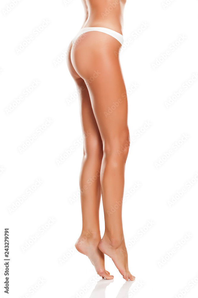 Beautiful woman legs and white panties on white background Beautiful woman legs and white panties on white background