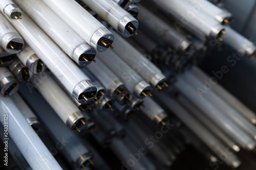 Close-up of a stack of disused and discarded neon lamp tubes waiting for recycling
