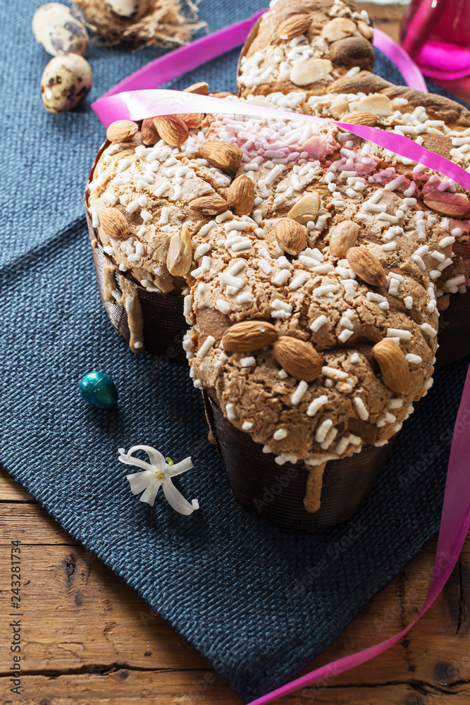 Colomba - italian easter dove cake on old rustic  board. Selective focus, free text space.