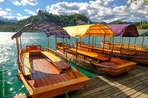 Colorful tourist boats on a lake.