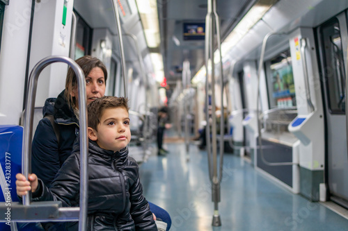 Mother and son travelling on the subway