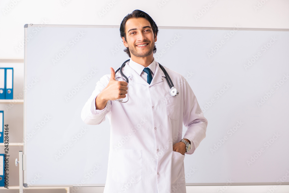 Young doctor in front of whiteboard 