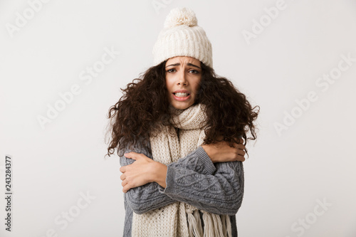Upset young woman wearing winter scarf photo