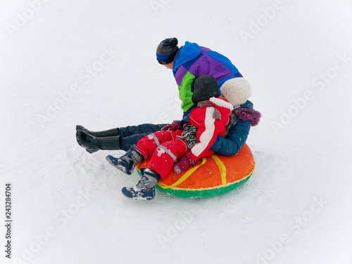 Winter fun. children ride from a snow hill.