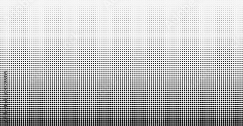 Halftone gradient vector background. From light to dark dots photo