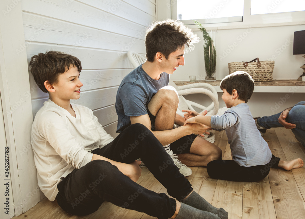 Portrait of brothers at home playing and happy. Concept of brothers playing and smiling at house Portrait of brothers at home playing and happy. Concept of brothers playing and smiling at house