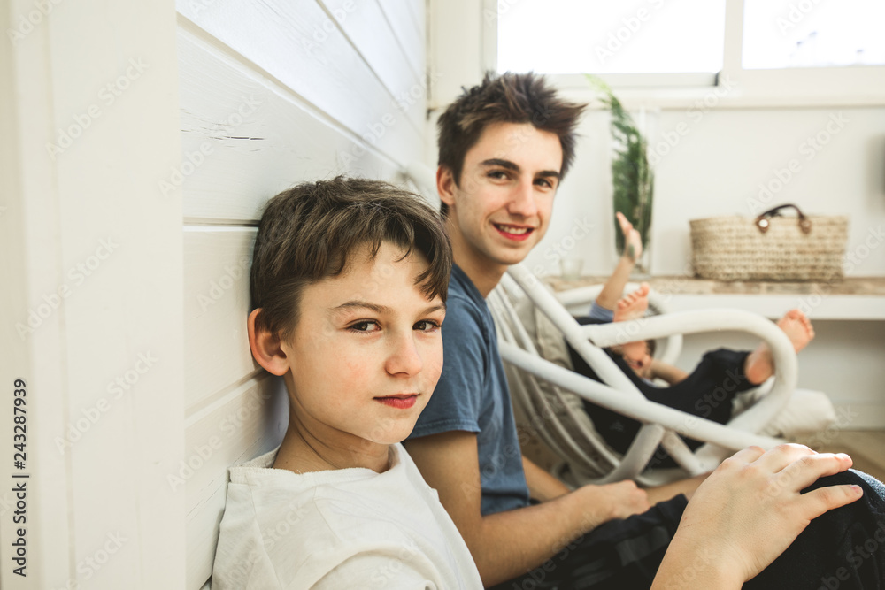 Portrait of brothers at home playing and happy. Concept of brothers playing and smiling at house Portrait of brothers at home playing and happy. Concept of brothers playing and smiling at house