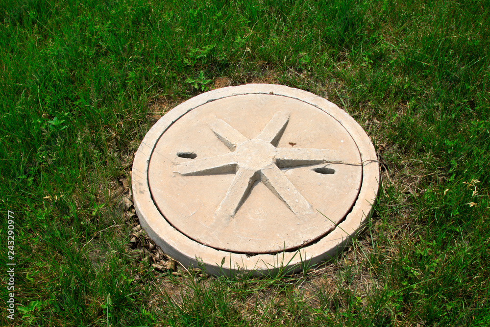 Fototapeta premium Cement covers in the lawn