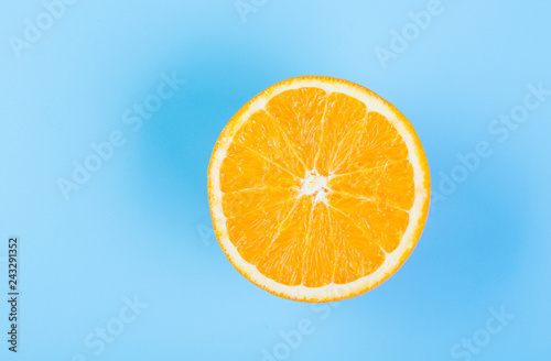 Orange slice on blue background  from above
