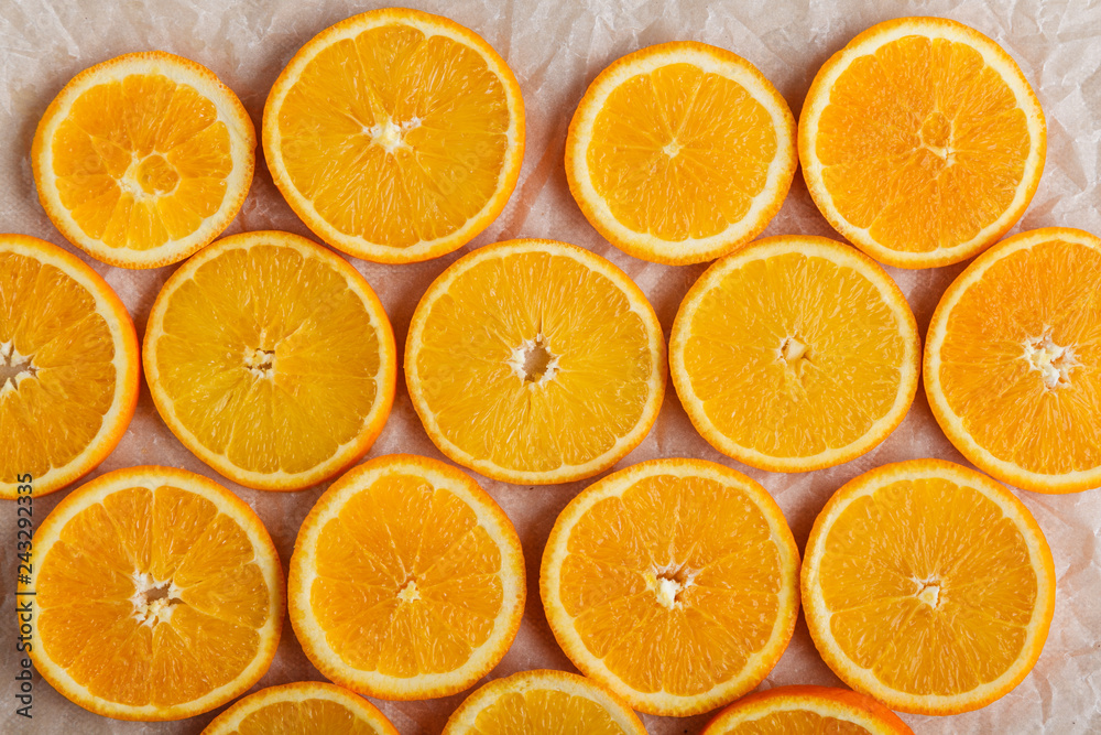 Abstract background with citrus orange slices on parchment paper. Close up. Top view. Studio photography. Abstract background with citrus orange slices on parchment paper. Close up. Top view. Studio photography.