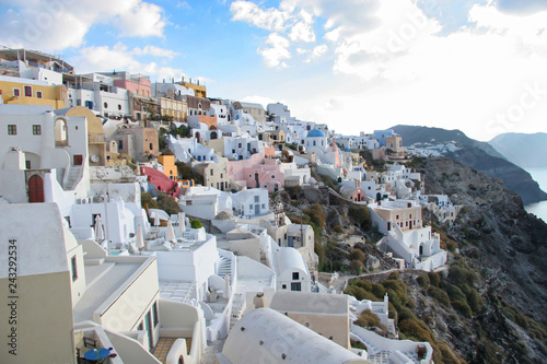 Oia town with tradional buildings painted white on the cliffside, Santorini, Greece.