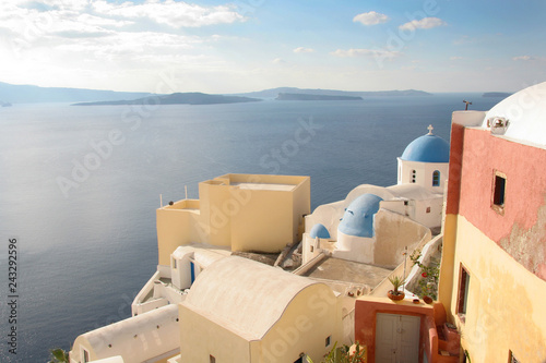 Traditional white church with a Blue dome, perched on the side of the cliff, Oia, Santorini, Greece.