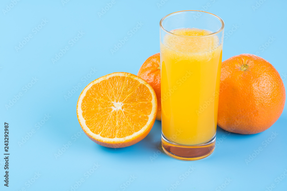 Orange juice and fresh oranges on blue background Orange juice and fresh oranges on blue background
