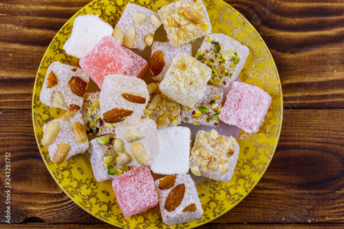 Turkish delight in a plate on wooden table