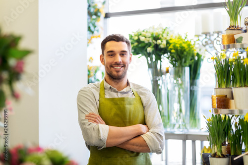 sale, small business and floristry concept - happy smiling florist man or seller at flower shop