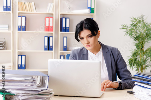 Middle aged businesslady unhappy with excessive work 