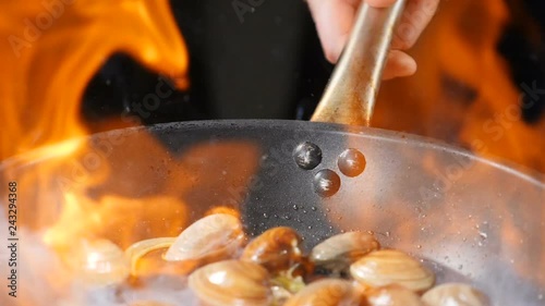 Restaurant concept. Cooking flambe dish. Traditional pasta with Shrimp, Clams, Mussels. Mouth-watering spaghetti with vongole clams. Slow motion. hd