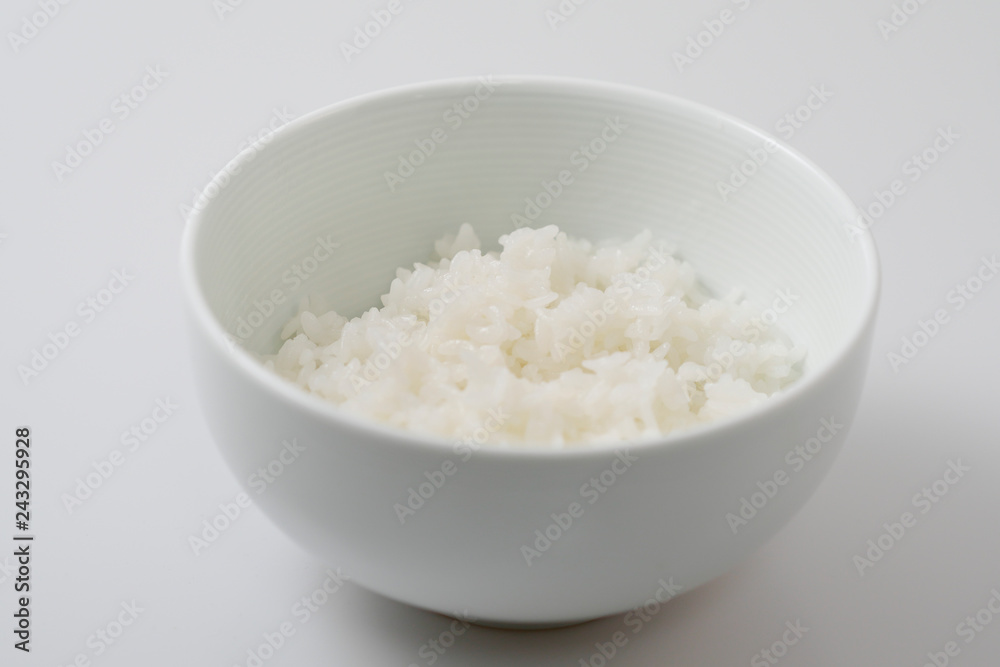 Rice in a white bowl on white background