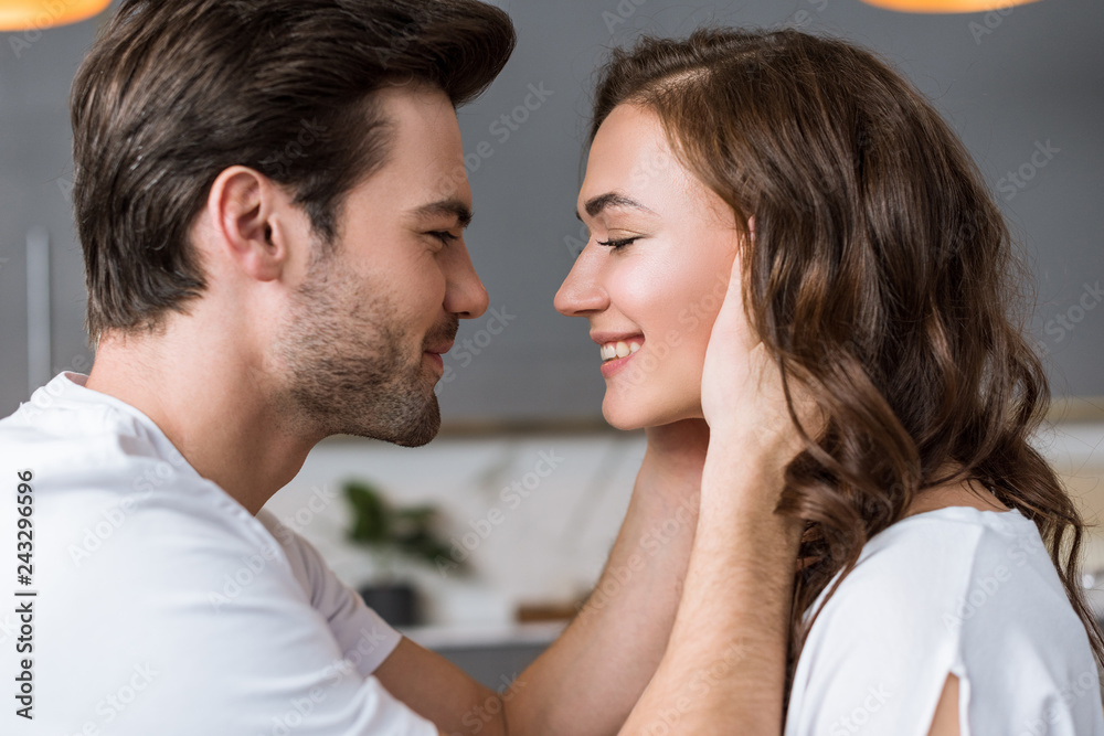 close up of happy man looking at girlfriend at home close up of happy man looking at girlfriend at home