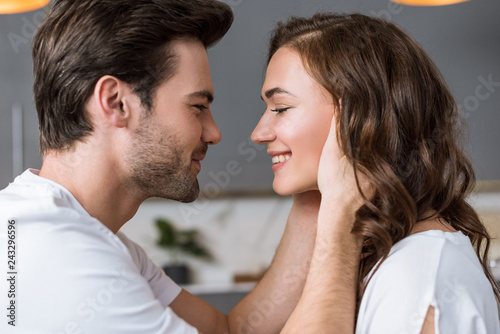 close up of happy man looking at girlfriend at home